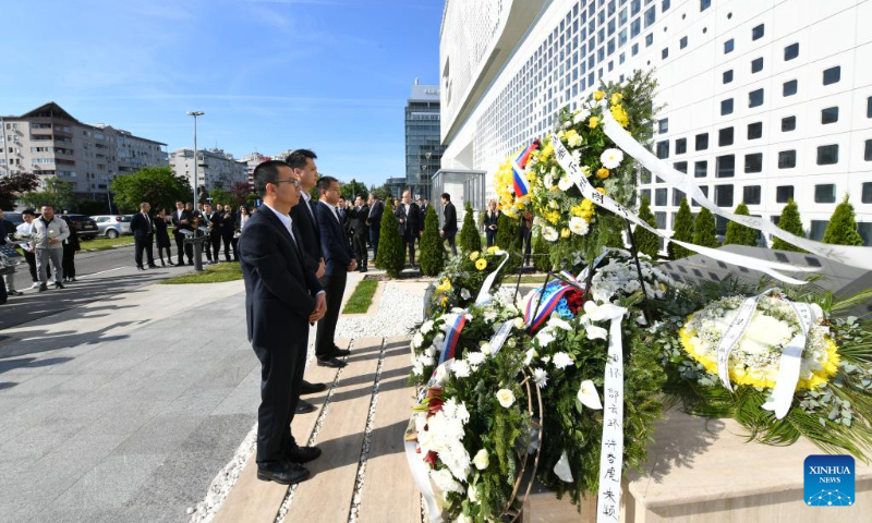 Representatives from Chinese enterprises mourn in front of the memorial monument at the site of the bombed former Chinese Embassy in the Federal Republic of Yugoslavia in Belgrade, Serbia, May 7, 2023. (Xinhua/Ren Pengfei)