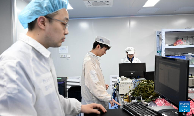 Lu Meina (R), Li Yang (C) and Nie Anran, members of Anhui Institute of Optics and Fine Mechanics of Chinese Academy of Science (CAS), work at a laboratory in Hefei Institutes of Physical Science of CAS in Hefei, capital of east China's Anhui Province, on April 18, 2023. (Xinhua/Huang Bohan)