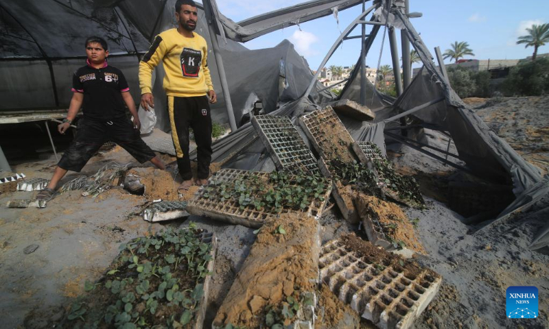 People inspect a damaged greenhouse following an airstrike in the southern Gaza Strip city of Rafah May 13, 2023. (Photo by Khaled Omar/Xinhua)