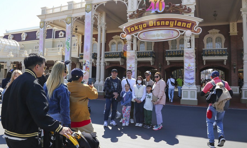 Visitors pose for photos at Tokyo Disneyland in Chiba Prefecture, Japan, April 10, 2023.(Photo: Xinhua)
