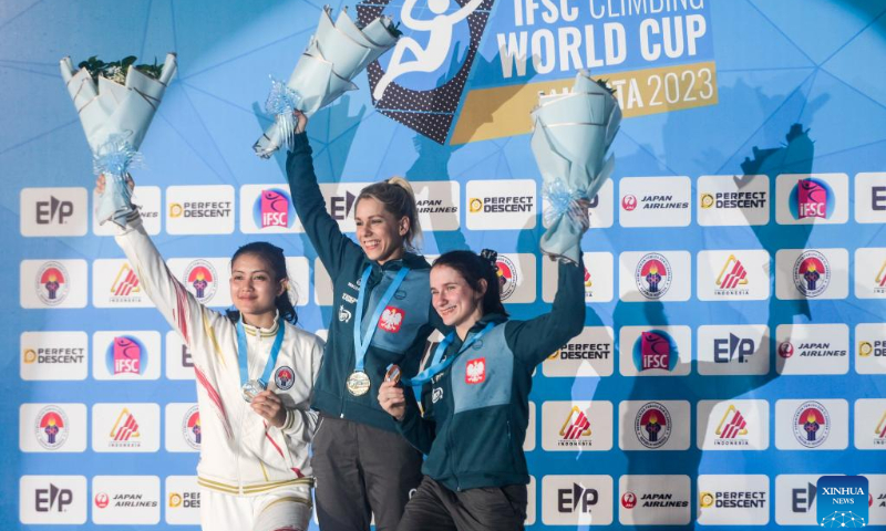 Gold medalist Aleksandra Miroslaw (C) of Poland, silver medalist Desak Made Rita Kusuma Dewi (L) of Indonesia and bronze medalist Aleksandra Kalucka of Poland pose during the awarding ceremony after the women's speed final of IFSC Climbing World Cup 2023 in Jakarta, Indonesia, May 7, 2023. (Xinhua/Zulkarnain)