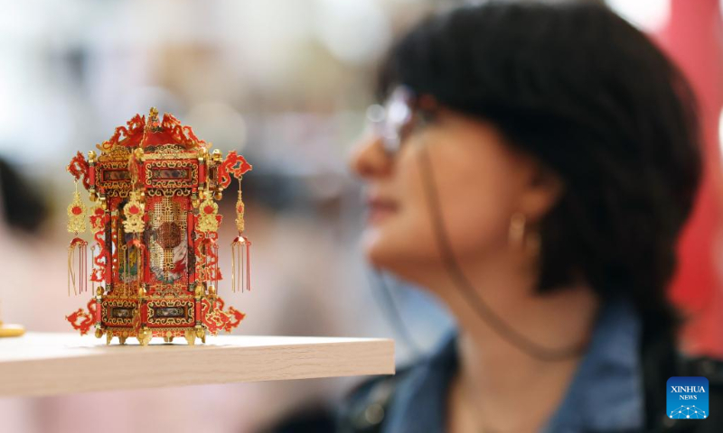 A woman visits an exhibition on the Chinese culture at the Porte de Versailles exhibition center in Paris, France, May 2, 2023. (Xinhua/Gao Jing)