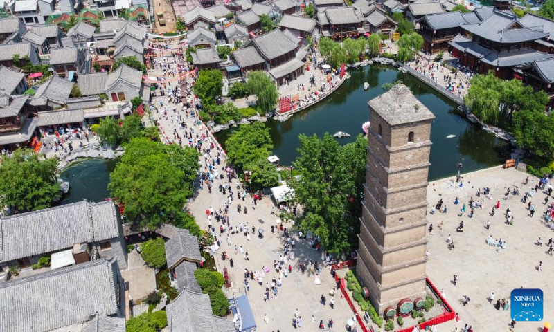 This aerial photo taken on May 2, 2023 shows tourists visiting Luoyi ancient city in Luoyang, central China's Henan Province. China is witnessing a travel boom during this year's five-day May Day holiday. (Photo by Huang Zhengwei/Xinhua)
