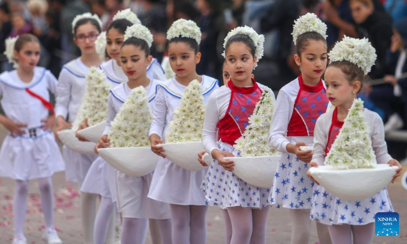 Girls attend a parade during a flower festival in Larnaca, Cyprus, May 7, 2023. (Photo by George Christophorou/Xinhua)