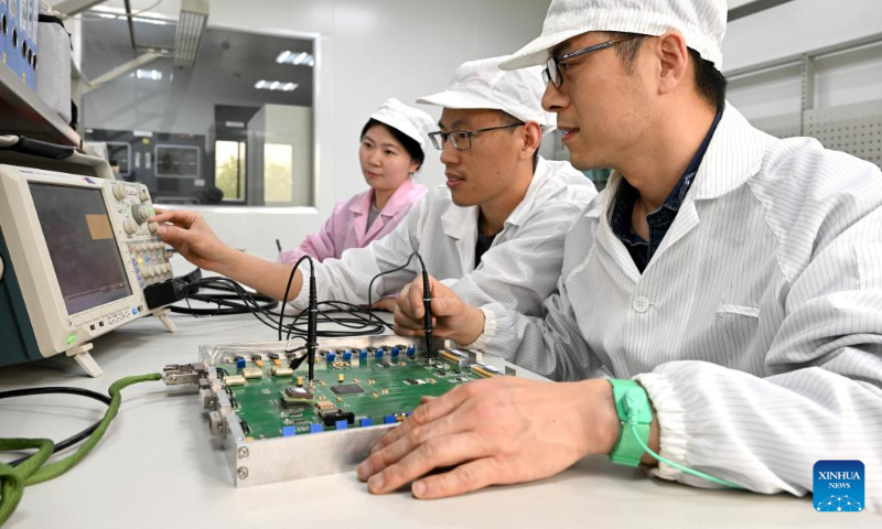 Zhao Xin (front), Chang Zhen (C) and Zhang Lu, members of Anhui Institute of Optics and Fine Mechanics of Chinese Academy of Science (CAS), work at a laboratory in Hefei Institutes of Physical Science of CAS in Hefei, capital of east China's Anhui Province, on April 18, 2023. (Xinhua/Huang Bohan)