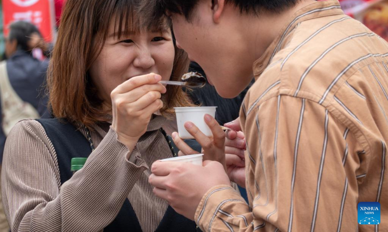People sample snacks during a Sichuan food festival held at Nakano Central Park, Tokyo, Japan, on May 14, 2023. The Sichuan food festival was held here from May 13 to May 14. (Xinhua/Zhang Xiaoyu)