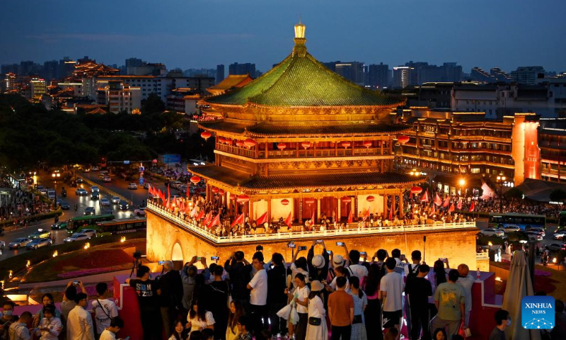 Tourists enjoy the night view of the ancient Bell Tower in Xi'an, capital of northwest China's Shaanxi Province, May 2, 2023. China has witnessed a travel boom during this year's five-day May Day holiday. (Photo by Zou Jingyi/Xinhua)