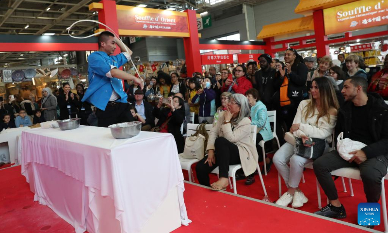 A chef demonstrates noodle-stretching skill during an exhibition on the Chinese culture at the Porte de Versailles exhibition center in Paris, France, May 2, 2023. (Xinhua/Gao Jing)