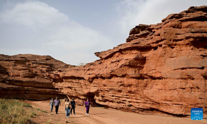 Tourists visit the West Dreamy Canyon in Alxa, north China's Inner Mongolia Autonomous Region, May 13, 2023. (Xinhua/Bei He)
