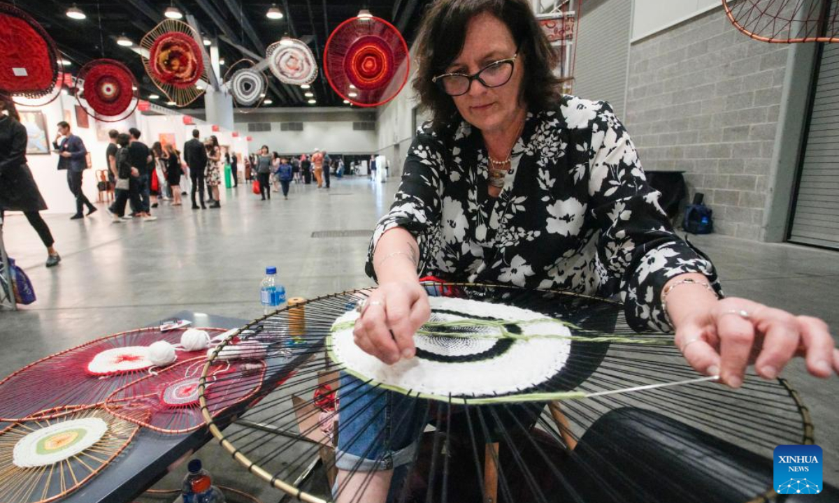 An artist creates her art piece during the Art Vancouver event at the Vancouver Convention Center in Vancouver, British Columbia, Canada, on May 4, 2023. Photo:Xinhua