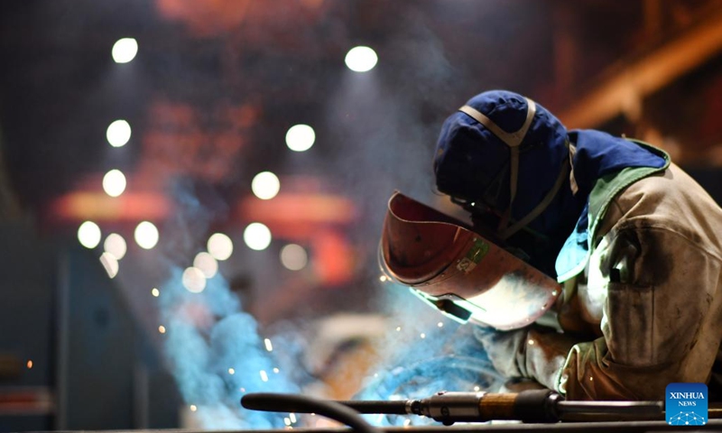 A worker performs production tasks at Harbin Electric Machinery Company Limited of Harbin Electric Corporation in Harbin, capital of northeast China's Heilongjiang Province, April 11, 2023. Harbin Electric Corporation, a veteran state-owned enterprise with a history of over 70 years, has been hailed as the cradle of China's power generation equipment manufacturing industry.(Photo: Xinhua)