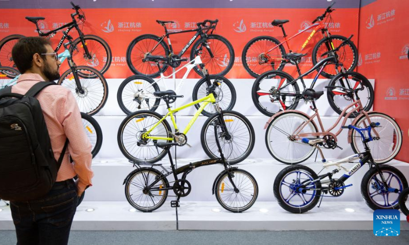 A visitor looks at bicycles displayed during the 31st China International Bicycle Fair in east China's Shanghai, May 5, 2023. (Xinhua/Cai Yang)
