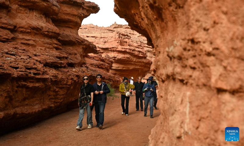 Tourists visit the West Dreamy Canyon in Alxa, north China's Inner Mongolia Autonomous Region, May 13, 2023. (Xinhua/Bei He)