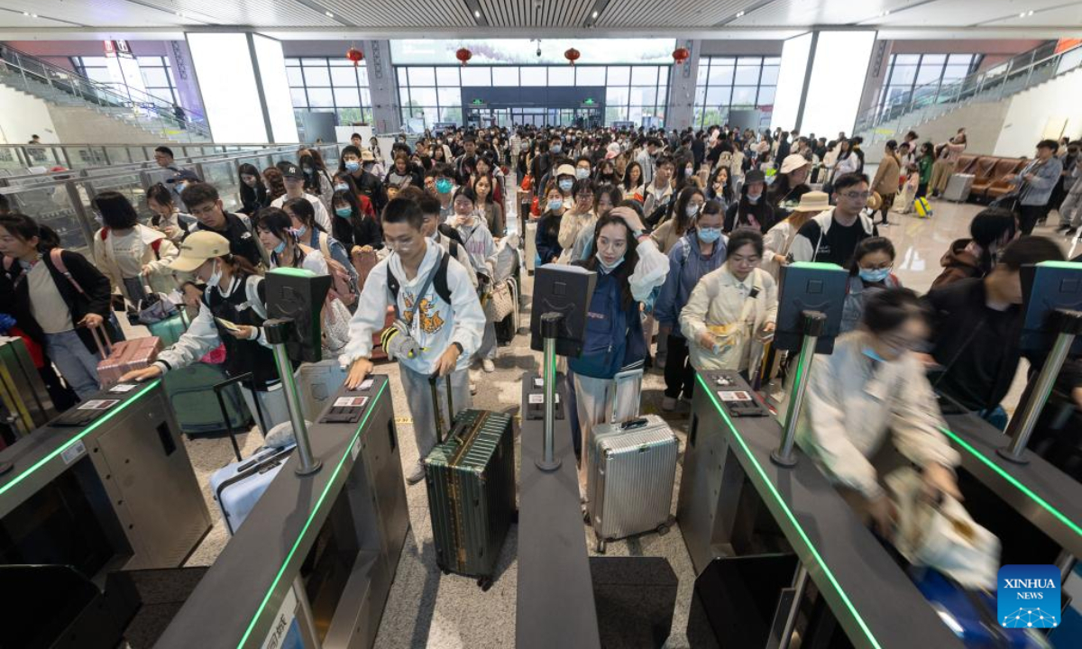 Passengers have their tickets checked at the waiting hall of a railway station in Huzhou, east China's Zhejiang Province, April 29, 2023. A travel rush is on as the country ushers in the 5-day Labor Day holiday on Saturday. Photo:Xinhua