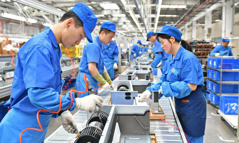 Workers assemble air conditioners at a factory in Qingdao, East China's Shandong Province, on May 16, 2023. Air conditioning enterprises have entered the peak season of production and sales and are running at full speed. In 2022, China's exports of central air conditioning equipment reached 13.5 billion yuan ($1.9 billion), a year-on-year increase of 21.0 percent. Photo: cnsphoto