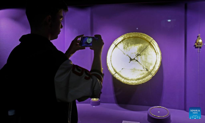 A visitor takes photo of exhibits at Romania's National History Museum which opens till late night as part of the European Night of Museums cultural initiative in downtown Bucharest, capital of Romania, May 13, 2023. (Photo by Cristian Cristel/Xinhua)