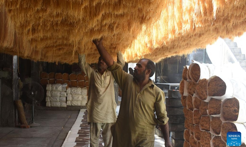 Workers check dried noodles at a local noodle factory in Lahore, Pakistan on April 12, 2023. Many Pakistani people buy dried noodles for an early morning meal before they start fasting during the holy month of Ramadan.(Photo: Xinhua)