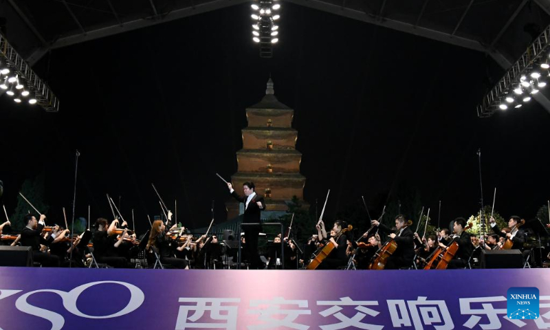 Members of the Xi'an Symphony Orchestra perform in an outdoor concert near the Giant Wild Goose Pagoda in Xi'an, northwest China's Shaanxi Province, Sept. 19, 2020. (Xinhua/Li Yibo)