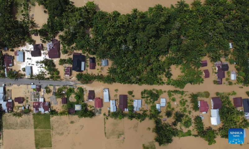 This aerial photo shows houses submerged by flood after heavy rain in Napai village in Aceh Barat district, Aceh Province, Indonesia, May 7, 2023. (Photo by Yulham/Xinhua)