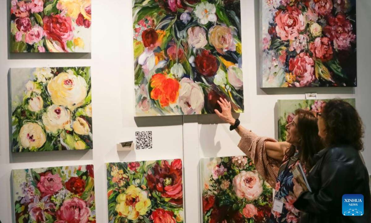 Visitors look at some paintings during the Art Vancouver event at the Vancouver Convention Center in Vancouver, British Columbia, Canada, on May 4, 2023. Photo:Xinhua