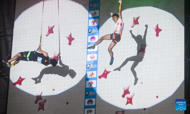 Nursamsa Raharjati (R) of Indonesia and Wang Xinshang of China react after the men's speed final of IFSC Climbing World Cup 2023 in Jakarta, Indonesia, May 7, 2023. (Xinhua/Zulkarnain)