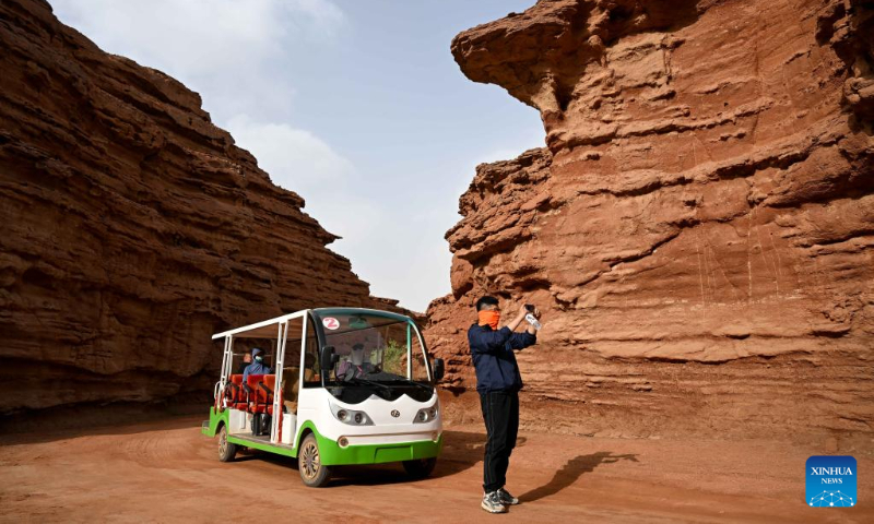 Tourists visit the West Dreamy Canyon in Alxa, north China's Inner Mongolia Autonomous Region, May 13, 2023. (Xinhua/Bei He)