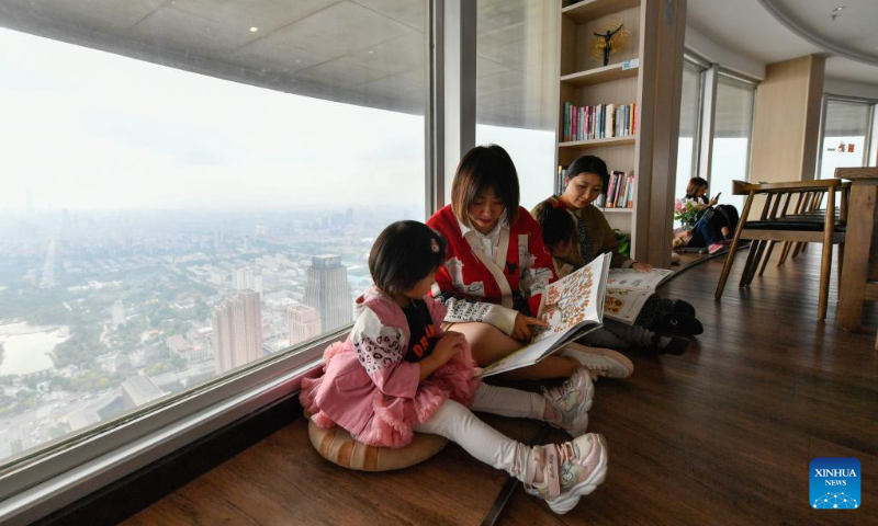 People read books at a bookstore in the Tianjin Television Tower in Hexi District of Tianjin, north China, April 22, 2023. Hexi District in north China's Tianjin Municipality has offered convenient reading service to its readers by developing a reading service system. With the system, libraries in the district can share their resources and readers can borrow and return books by one stop. (Xinhua/Sun Fanyue)