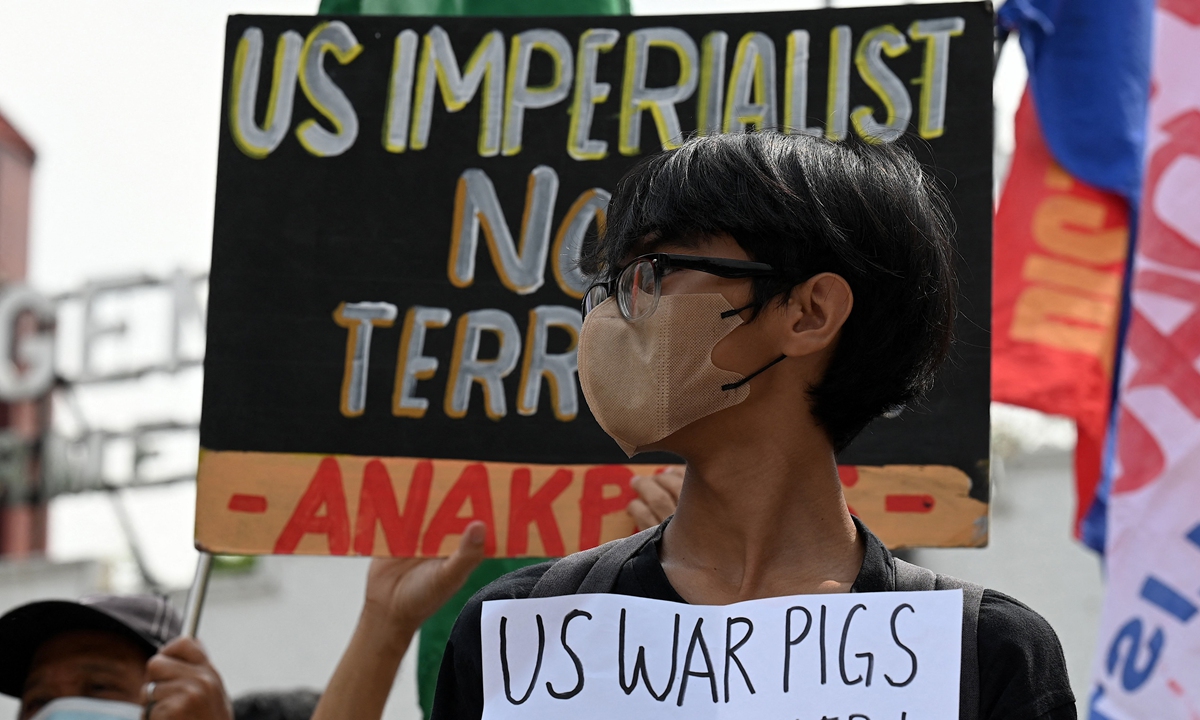 An activist holds a placard during a protest against the Balikatan joint military exercises between the Philippines and the US, outside Camp Aguinaldo in Quezon City, suburban Manila on April 11, 2023. The drill is the largest ever between the two nations with more than 17,000 troops involved. Photo: VCG