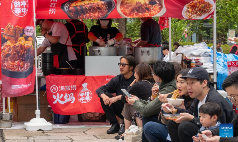 Visitors are pictured during a Sichuan food festival held at Nakano Central Park, Tokyo, Japan, on May 14, 2023. The Sichuan food festival was held here from May 13 to May 14. (Xinhua/Zhang Xiaoyu)