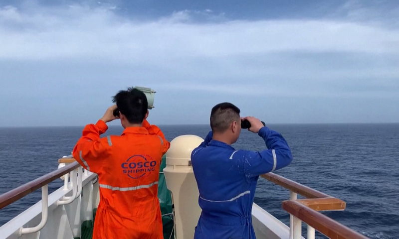 COSCO shipping crew members are searching for the crew members of the capsized fishing vessel Lupeng Yuanyu 028 at sea on May 17, 2023. Photo: VCG