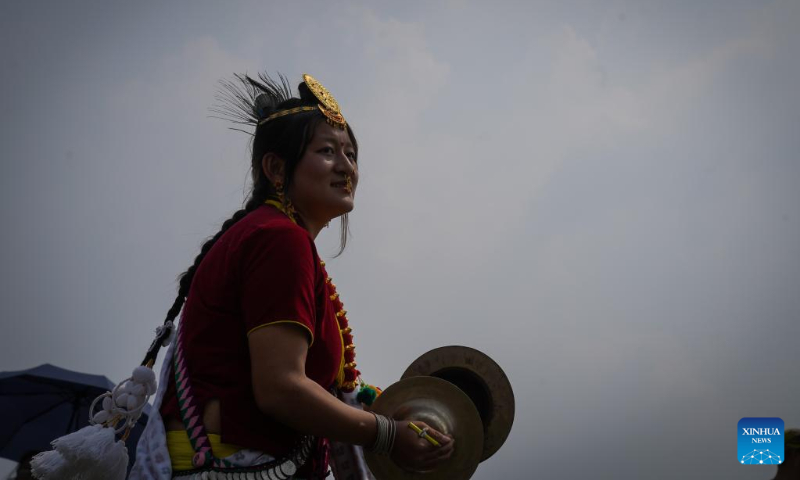 A woman from the Kirat community plays the cymbal during the celebration of the Ubhauli festival in Kathmandu, Nepal, May 13, 2023. (Photo by Hari Maharjan/Xinhua)
