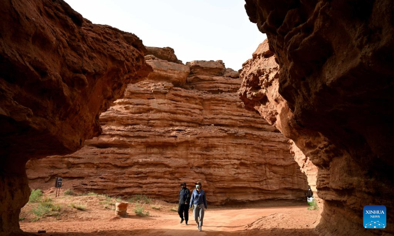 Tourists visit the West Dreamy Canyon in Alxa, north China's Inner Mongolia Autonomous Region, May 13, 2023. (Xinhua/Bei He)