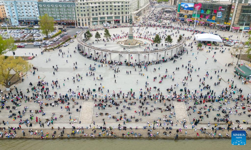This aerial photo taken on May 3, 2023 shows people visiting the square of the Flood Control Monument in Harbin, northeast China's Heilongjiang Province. China has witnessed a travel boom during this year's five-day May Day holiday. (Xinhua/Zhang Tao)