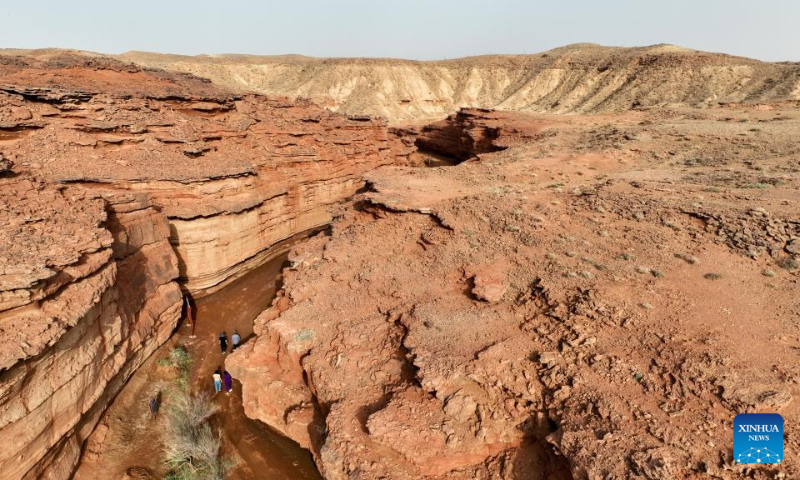 Tourists visit the West Dreamy Canyon in Alxa, north China's Inner Mongolia Autonomous Region, May 13, 2023. (Xinhua/Bei He)