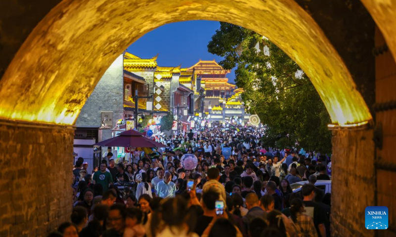 Tourists enjoy night time at the ancient town of Xiangyang City, central China's Hubei Province, April 30, 2023. China is witnessing a travel boom during this year's five-day May Day holiday. (Photo by Yang Dong/Xinhua)