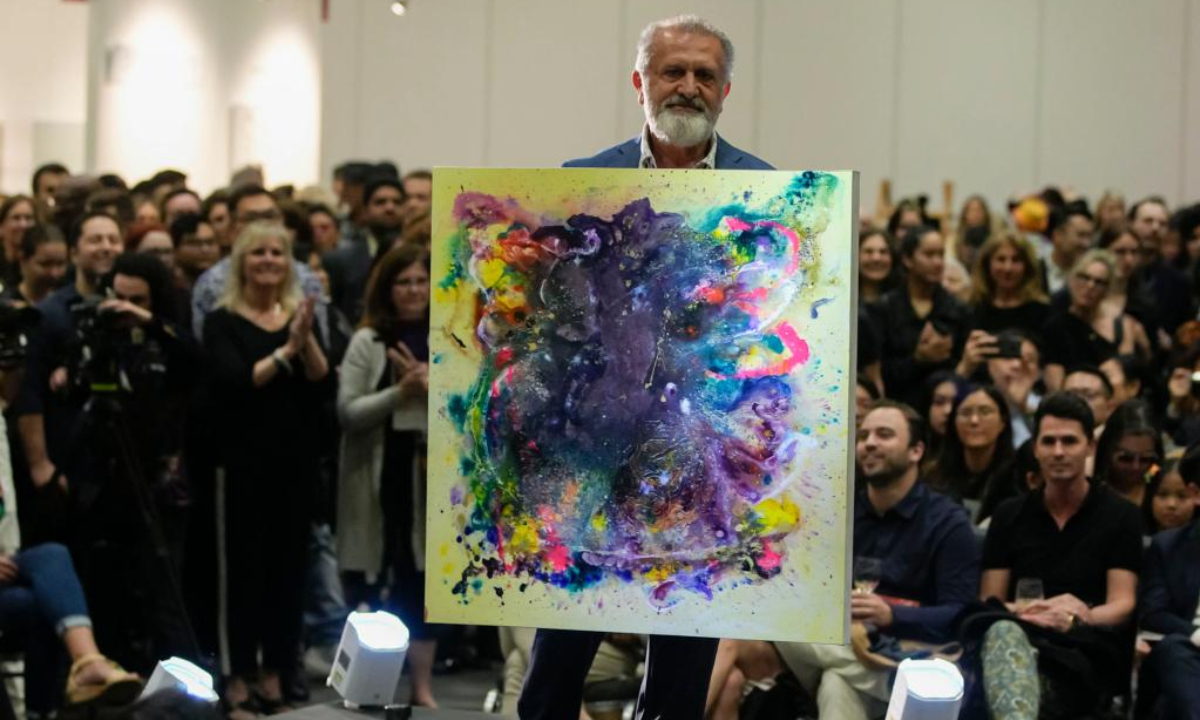 An artist showcases his work at a runway show during the Art Vancouver event at the Vancouver Convention Center in Vancouver, British Columbia, Canada, on May 4, 2023. Art Vancouver, an art exhibition and trade show, runs from May 4 to 7, featuring over 100 exhibitors from around the world. Photo:Xinhua