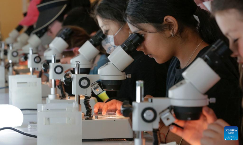 Children watch the pond water organisms through a microscope during the Science Rendezvous event at the University of British Columbia in Vancouver, British Columbia, Canada, on May 13, 2023. (Photo by Liang Sen/Xinhua)