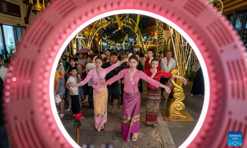 Performers livestream at an ancient Dai town in Mangshi City, Dehong Dai and Jingpo Autonomous Prefecture, southwest China's Yunnan Province, April 11, 2023. The ancient town features local cultural elements to enhance tourists' night tour experience and boost the local cultural tourism.(Photo: Xinhua)