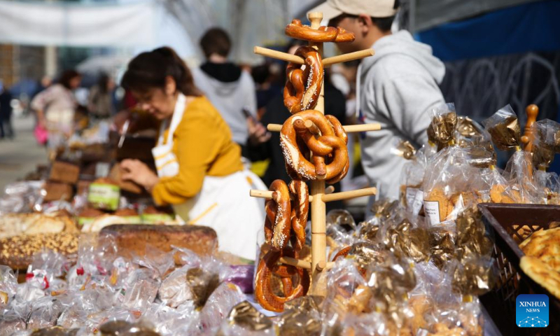 Vendors prepare bread at a bread festival in Brussels, Belgium, May 6, 2023. A bread festival was held in Brussels on Saturday to let people taste and buy various kinds of bread product from European countries. (Xinhua/Zheng Huansong)