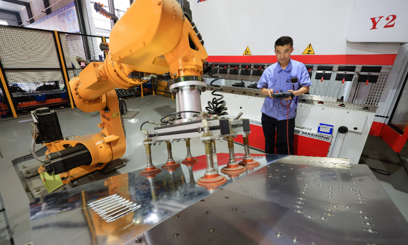 An automatic bending robot is processing a distribution cabinet on June 22, 2022 in the workshop of a company located in Hefei, Anhui Province. Photo: VCG