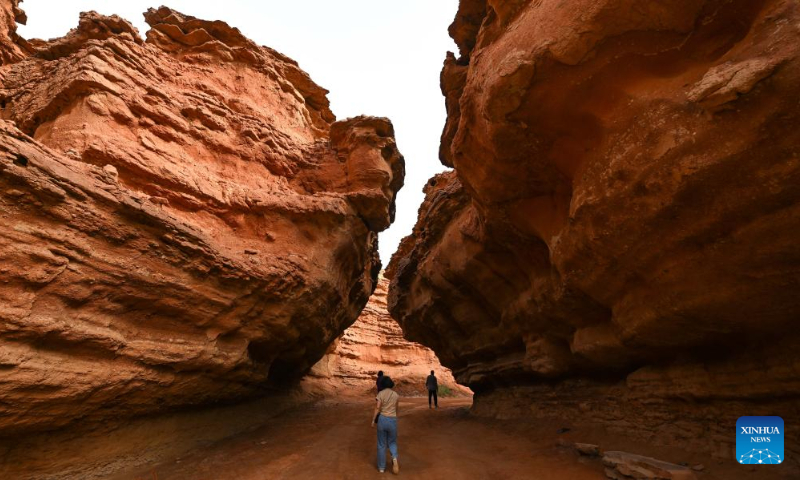 Tourists visit the West Dreamy Canyon in Alxa, north China's Inner Mongolia Autonomous Region, May 13, 2023. (Xinhua/Bei He)