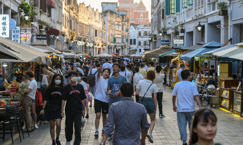 Tourists visit the old arcade street in Haikou, Hainan Province to experience the cultural heritage and taste local cuisine on April 30, 2023. Photo: VCG