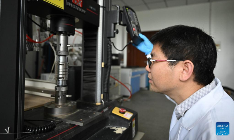 Jiang Weibin, researcher of the Institute of Solid State Physics of Chinese Academy of Science (CAS), measures the mechanical strength of a spring at Hefei Institutes of Physical Science of CAS in Hefei, capital of east China's Anhui Province, on April 19, 2023. (Xinhua/Huang Bohan)