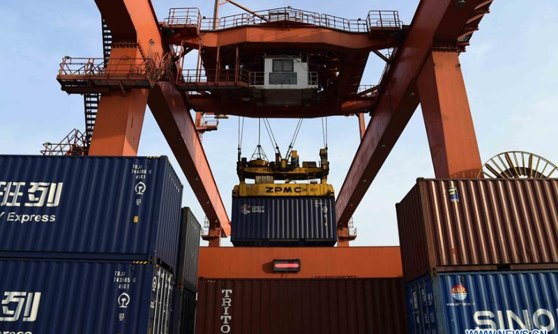 A gantry crane loads cargo onto a freight train bound for Central Asia at the Jiaozhou Bay International Logistics Harbour in Qingdao, East China's Shandong Province, May 7, 2018. Photo: Xinhua