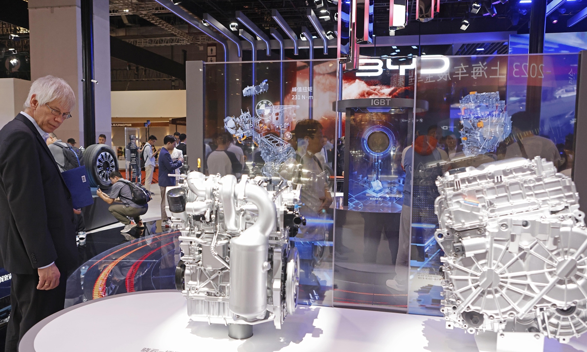 A visitor to the BYD booth looks at an engine at the 20th Shanghai International Automobile Industry Exhibition on April 18, 2023. Photo: VCG