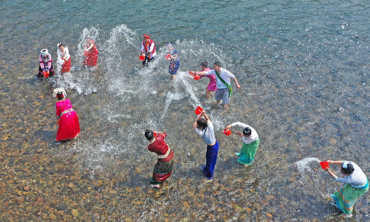 People of the Dai ethnic group celebrate the Water-Sprinkling Festival on April 12, 2023 in Taizhou, East China's Zhejiang Province. People sprinkle water at each other to pray for good fortune during the festival, which is also the New Year festival of the Dai ethnic group, who primarily live in the Xishuangbanna Dai Autonomous Prefecture and Dehong Dai and Jingpo Autonomous Prefecture in Southwest China's Yunnan Province. Photo: VCG