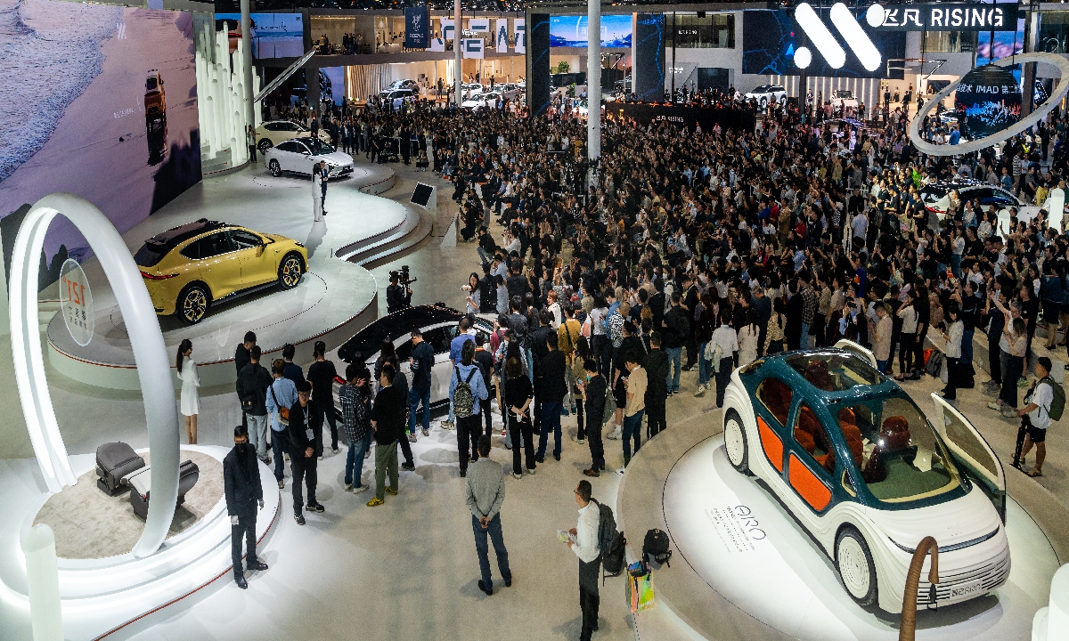 Visitors gather at the IM Motors booth to watch the brand's marketing campaign at the auto Show on April 18, 2023. Photo: VCG