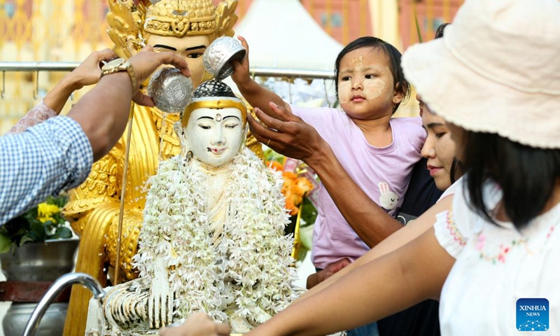 People pour water over a Buddha statue on the first day of the Myanmar calendar New Year in Yangon, Myanmar, April 17, 2023.(Photo: Xinhua)