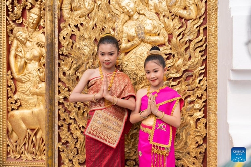 Girls pose for photos during the celebration of the Songkran Festival or the Lao New Year, in Luang Prabang, Laos, April 15, 2023. The Lao New Year, celebrated from April 14 to 16, is the most important festival in the Lao calendar and also a time of endless fun for the Laotians(Photo: Xinhua)