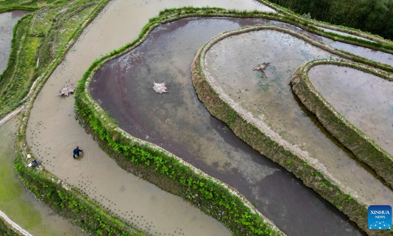 This aerial photo taken on April 17, 2023 shows a villager working in terraced fields in Jiabang Town of Congjiang County, Qiandongnan Miao and Dong Autonomous Prefecture, southwest China's Guizhou Province. Farmers across China are busy with agricultural production in spring.(Photo: Xinhua)